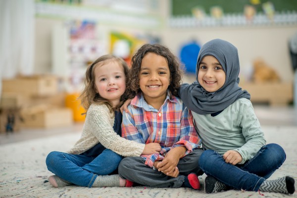 Three little girls smiling